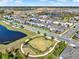 Aerial view of a neighborhood dog park surrounded by community homes and a pond at 17055 Wynford Ln, Winter Garden, FL 34787