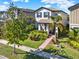 Charming two-story home with landscaped front yard and inviting brick pathway at 17055 Wynford Ln, Winter Garden, FL 34787