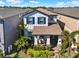 Charming two-story home with inviting front porch, manicured lawn, and mature landscaping at 17055 Wynford Ln, Winter Garden, FL 34787