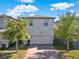 Charming two-story home with a well-maintained front yard, brick driveway, and a two-car garage at 17055 Wynford Ln, Winter Garden, FL 34787