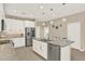 Bright kitchen featuring white cabinets, granite countertops, stainless steel appliances, and an island with a sink at 17055 Wynford Ln, Winter Garden, FL 34787
