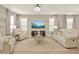 Spacious living room with comfortable seating, stylish decor, large windows, and an open view to the dining area at 17055 Wynford Ln, Winter Garden, FL 34787