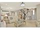 Open concept living room with view to the stairs and kitchen area. Neutral tones and elegant finishes throughout at 17055 Wynford Ln, Winter Garden, FL 34787