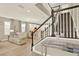 A bright living room with a staircase, connecting the rooms with easy access, and modern decor at 17055 Wynford Ln, Winter Garden, FL 34787