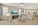 Elegant living room featuring modern decor, a large TV, a mirrored coffee table, and an open floor plan at 17055 Wynford Ln, Winter Garden, FL 34787