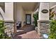 Inviting front porch with stone pillars, brick flooring, a seating area, and a decorative front door with glass inserts at 17055 Wynford Ln, Winter Garden, FL 34787