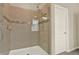 Tiled shower with glass enclosure and decorative accent stripe, perfect for a modern bathroom at 17055 Wynford Ln, Winter Garden, FL 34787