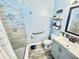 Bathroom featuring a shower, hand rails, and tile floor and walls at 1795 Orange View Ct, Kissimmee, FL 34746