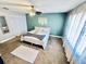 A large bedroom features a ceiling fan, light green walls, and natural light through the windows at 1795 Orange View Ct, Kissimmee, FL 34746