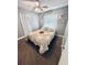 A bedroom features a bed with a patterned comforter, a ceiling fan, and a window with patterned curtains at 1795 Orange View Ct, Kissimmee, FL 34746