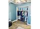 Walk-in closet with clothes hanging on a rod and blue storage boxes on a shelf at 1795 Orange View Ct, Kissimmee, FL 34746
