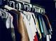 A clothes closet is well-stocked with clothes hanging on hangers at 1795 Orange View Ct, Kissimmee, FL 34746