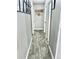 Hallway with wood look flooring and grey walls decorated with wall art at 1795 Orange View Ct, Kissimmee, FL 34746