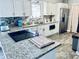 Modern kitchen featuring granite countertops and stainless steel appliances at 1795 Orange View Ct, Kissimmee, FL 34746
