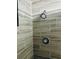 A tiled shower features a wall-mounted shower head and tiled walls at 1795 Orange View Ct, Kissimmee, FL 34746