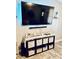 Entertainment area with a large flatscreen TV and stylish storage shelves at 1795 Orange View Ct, Kissimmee, FL 34746