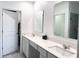 Bright bathroom boasts double sinks with quartz countertops and modern fixtures at 1902 Presley Pl, Kissimmee, FL 34746