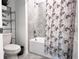 Well-lit bathroom features a shower-tub combo, and decorative shelving, perfect for a relaxing experience at 1902 Presley Pl, Kissimmee, FL 34746