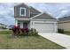 Charming two-story home with a well-manicured lawn and a two car garage at 1902 Presley Pl, Kissimmee, FL 34746