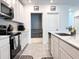 A modern kitchen with white cabinets and stainless steel appliances at 1902 Presley Pl, Kissimmee, FL 34746