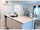 Bright kitchen with quartz counters, an island with seating, and stainless steel appliances at 1902 Presley Pl, Kissimmee, FL 34746