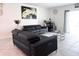 Comfortable living room with leather sofas, stylish decor, and a bright, airy atmosphere at 1902 Presley Pl, Kissimmee, FL 34746