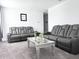 Comfortable living room with modern sofas, plush carpet, and a stylish coffee table at 1902 Presley Pl, Kissimmee, FL 34746