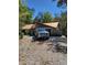 View of house with stone accents and a truck parked in the driveway at 21230 Orange Ct, Mount Dora, FL 32757