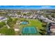 Aerial view of community featuring pool, tennis courts, and lush landscaping at 2126 Derwent Dr, Davenport, FL 33896