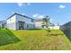 Expansive backyard featuring lush green grass, patio seating, and partial fencing at 2126 Derwent Dr, Davenport, FL 33896