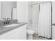 Clean, white bathroom with a shower-tub combo, modern fixtures, and neutral finishes at 2126 Derwent Dr, Davenport, FL 33896
