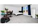Bright bedroom with large windows, blue curtains, and a minimalist bed at 2126 Derwent Dr, Davenport, FL 33896