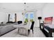 Bright dining area featuring a modern chandelier, stylish decor, and sliding glass doors to the outdoor space at 2126 Derwent Dr, Davenport, FL 33896