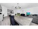 Open-concept dining and kitchen area featuring a modern chandelier, stainless appliances, and an island at 2126 Derwent Dr, Davenport, FL 33896