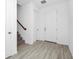 Bright entryway featuring light wood-look floors and a staircase leading to the upper level at 2126 Derwent Dr, Davenport, FL 33896
