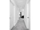 Well-lit hallway with neutral walls and carpeting, providing seamless access to various rooms at 2126 Derwent Dr, Davenport, FL 33896