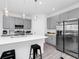 Modern kitchen with stainless steel appliances, a white countertop island, and gray cabinets at 2126 Derwent Dr, Davenport, FL 33896