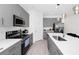 Modern kitchen featuring gray cabinetry, stainless steel appliances and a bright white countertop island at 2126 Derwent Dr, Davenport, FL 33896