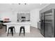 Modern kitchen with stainless steel appliances, a white countertop island, and gray cabinets at 2126 Derwent Dr, Davenport, FL 33896