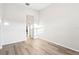 Bright bedroom featuring wood-look flooring, neutral walls, and a light-filled doorway at 250 Lakeridge Ct, Winter Springs, FL 32708