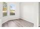 Bedroom with wood-look flooring, natural light, and views of the backyard at 250 Lakeridge Ct, Winter Springs, FL 32708