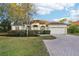Inviting single-story home featuring a brick driveway and well-maintained front yard at 250 Lakeridge Ct, Winter Springs, FL 32708