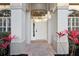 Close-up of a stylish front entrance with brick pavers and decorative plants at 250 Lakeridge Ct, Winter Springs, FL 32708