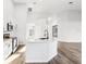 Bright kitchen boasts white cabinets, stainless steel appliances, and center island with granite countertops at 250 Lakeridge Ct, Winter Springs, FL 32708