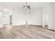 Spacious living room with light wood flooring, arched doorways, and seamless flow at 250 Lakeridge Ct, Winter Springs, FL 32708