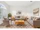 Staged living room with sofa, chairs and coffee table, all situated on an area rug at 250 Lakeridge Ct, Winter Springs, FL 32708