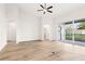 Open-concept living room featuring new floors, high ceilings and sliding glass doors at 250 Lakeridge Ct, Winter Springs, FL 32708