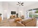 Staged living room boasts abundant natural light, modern furnishings, and backyard access at 250 Lakeridge Ct, Winter Springs, FL 32708