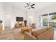 Staged living room with natural light, modern furniture, backyard access, and new flooring at 250 Lakeridge Ct, Winter Springs, FL 32708