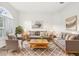 Bright living room featuring neutral furniture, stylish decor, and a large window for ample natural light at 250 Lakeridge Ct, Winter Springs, FL 32708